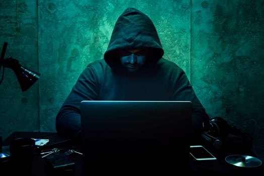 Hacker programmer using computer in dark room