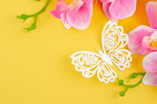 The Butterfly Paper Cut with pink color orchid on yellow background