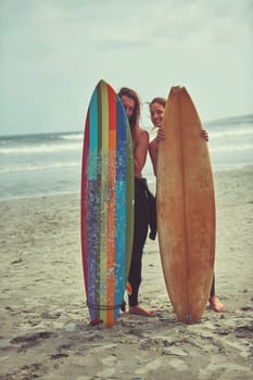 Do whatever floats your board. a young couple spending the day out surfing.