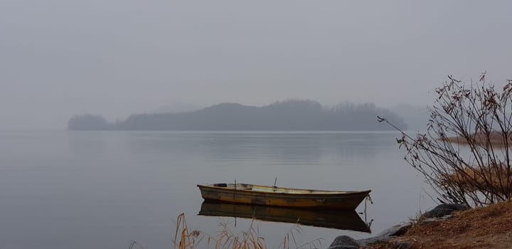 sky,morning,water,mist,calm,boat,loch,lake,fog,horizon,reflection,river,sea,vehicle