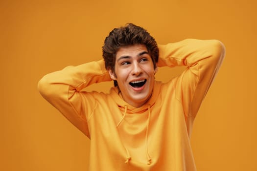 Young man over yellow background with surprised facial expression