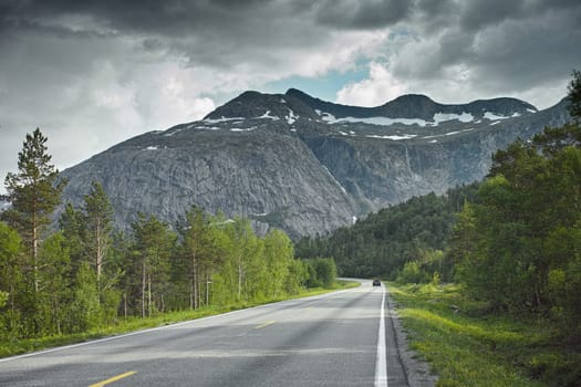 Road, mountain and travel landscape, trees and nature with direction and destination with asphalt and highway. Environment, street and location with journey and traveling view outdoor with horizon