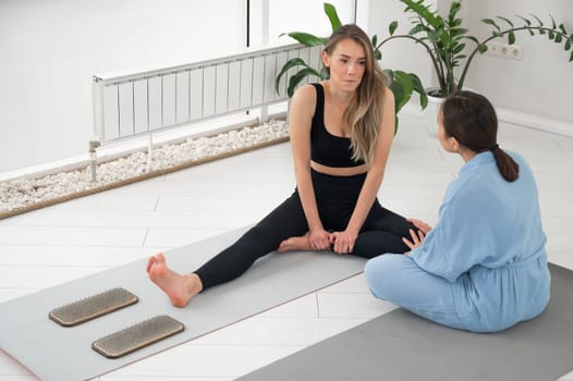 The therapist supports the client after standing on the sadhu boards. Nailing practice.