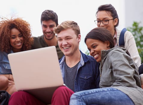 Laptop, laughing and group of students outdoor on university e learning app, online class or remote studying. Happy diversity people, youth or friends on college campus, computer or digital education