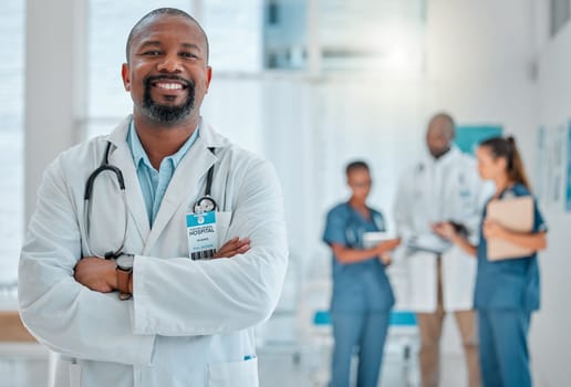 Happy, doctor and portrait of black man with crossed arms for medical help, insurance and trust. Healthcare, hospital team and face of professional male health worker for service, consulting and care