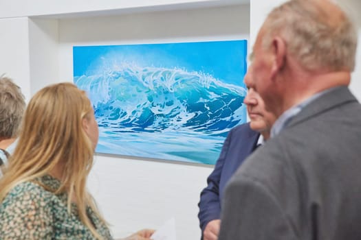 Skagen, Denmark, May, 2023: Visitors look at the paintings in gallery