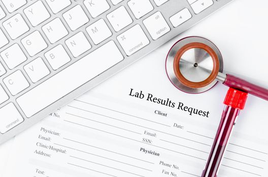 Lab results request form and sample blood in tube with stethoscope medical.