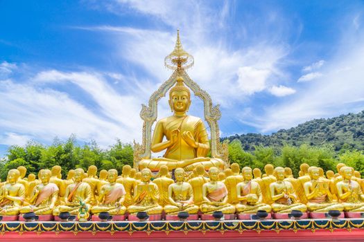 Row of disciple statues surrounding big buddha statue in public to the general public worship worship, Thailand.