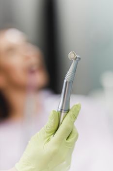 Shot of an unrecognisable dentist holding dental tools in an office.