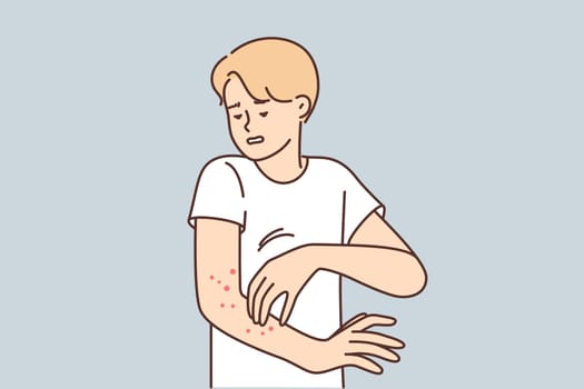 Man with rash on arm suffers from itching and eczema caused by infection that affects skin