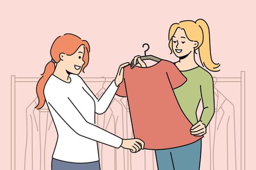Smiling consultant help client with clothes choice