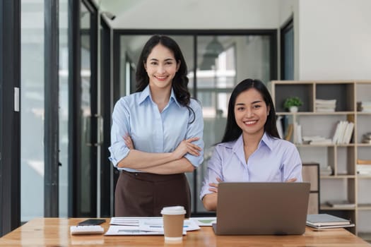 Two business workers smiling happy at the office