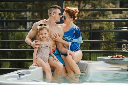 In summer, the family rests in the outdoor hot tub