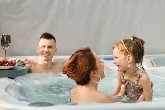 In summer, the family rests in the outdoor hot tub