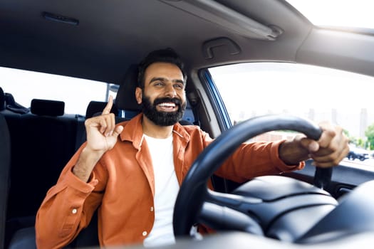 Cheerful Indian Man Riding Car And Singing Sitting Inside Vehicle