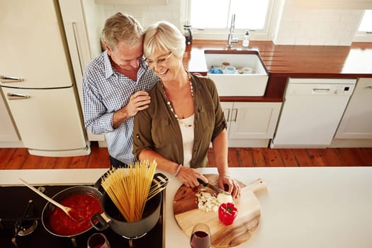 Affection, hug or happy old couple kitchen cooking with love or healthy food for dinner together at home. Embrace or above of senior woman helping or laughing with elderly husband in meal preparation