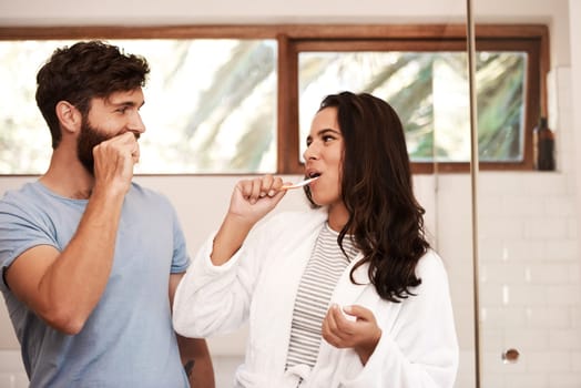 Dental, home bathroom and happy couple brushing teeth with toothbrush, toothpaste and morning self care. Tooth, enamel care routine and people cleaning mouth for health, hygiene or oral wellness