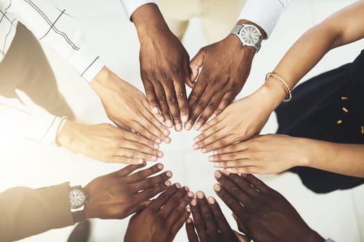 We each bring a unique skill set to the team. Closeup shot of a group of businesspeople joining their hands together.