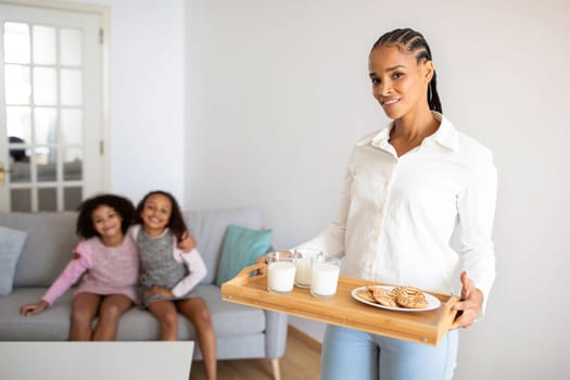 Black Mother Holding Tray With Lunch For Daughters At Home