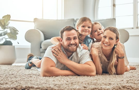 Portrait of mother, father and children on living room floor for bonding, quality time and playing together. Happy family, smile and mom and dad with girls for care, love and relax at home on weekend