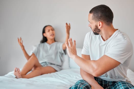 Argument, stress and couple fighting in bed for breakup, divorce or toxic relationship at home. Break up, angry and upset man and woman arguing in bedroom for cheating, affair or financial difficulty