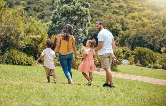 Family, kids and walking in the park for bonding, fun and care in summer outside. Mother, father and parents playfully walk with children, son and daughter siblings in a garden for bond