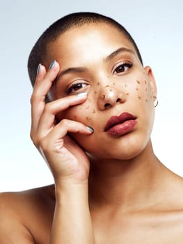 Im under no obligation to make sense to you. Studio shot of a beautiful young woman posing with glitter freckles on her face.