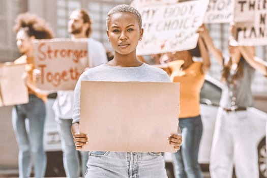 Protest, sign and mockup with a black woman activist holding cardboard during a rally or demonstration. Poster, freedom and politics with a young female fighting for human rights or equality
