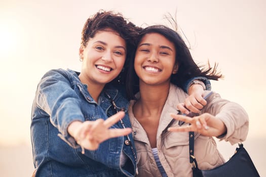 Lgbtq, couple and peace sign portrait of interracial lesbian women together on travel adventure. Summer, friends and smile of people in miami on vacation with happiness, hug and freedom lifestyle.