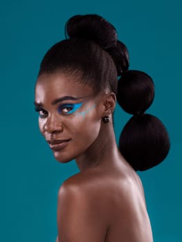 Portrait, beauty and makeup with a model black woman in studio on a blue background for hair or fashion. Face, cosmetics and haircare with an attractive young female person posing for haircare