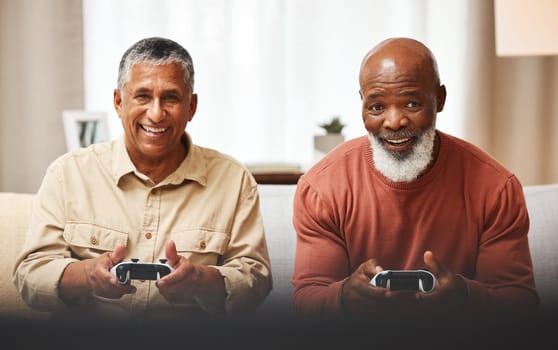Gamer, fun and senior black man friends playing a video game together in the living room of a home. Sofa, funny or retirement with a mature male and friend gaming or bonding during a visit in a house