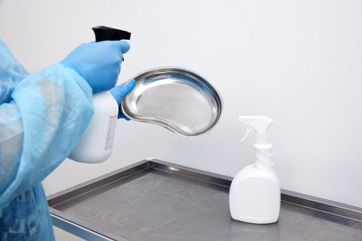 disinfecting medical instruments with sprayer in clinic. Disinfection concept