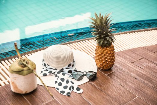 Summer Vacation and Swimming Pool Relaxation Lifestyles Concept, Mix Fruit and Accessory Woman Beside Swimming Pools at The Beach Vacations. Tropical Leisure Activities Relaxing and Holiday Resort