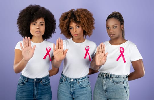 Black Women With Pink Breast Cancer Ribbons Gesturing Stop, Studio