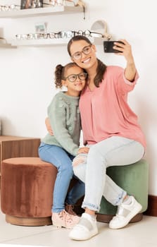 Glasses, retail and selfie with mother and child in vision and optometry store for eyewear. Shopping, photo and parent taking picture in eyewear shop for eye care, eye health ophthalmology