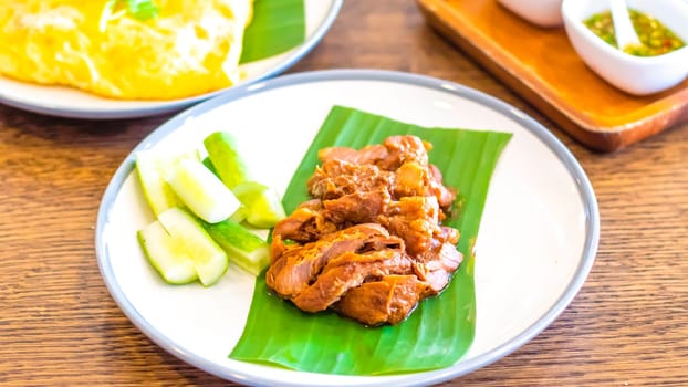 Thai food Fried Pork on banana leaf with Garlic Rice and vegetable