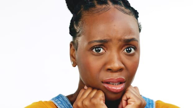 Face, fear and worried with a black woman in studio isolated on a white background looking afraid. Portrait, scared and phobia with a young female feeling alone, helpless or overwhelmed by emotions
