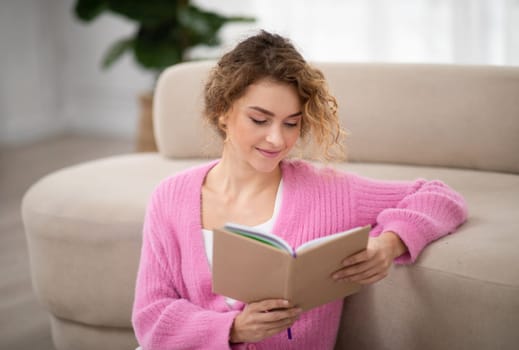 Portrait Of Beautiful Young Female Reading Book At Home