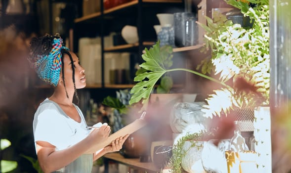 Checklist, small business or black woman writing plants or flowers or plants for commerce or stock inventory. Management, store manager or entrepreneur planning or working on floral growth inspection
