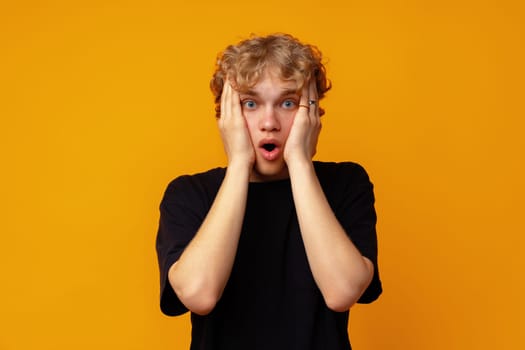 Young man over yellow background with surprise facial expression