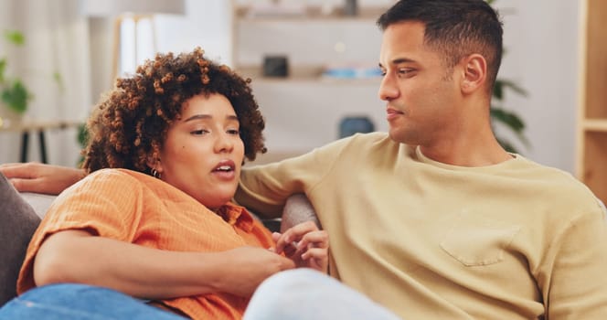 Trust, empathy and a couple talking on a sofa in the living room of their home together for understanding or support. Communication, love or conversation with a man and woman bonding through sympathy