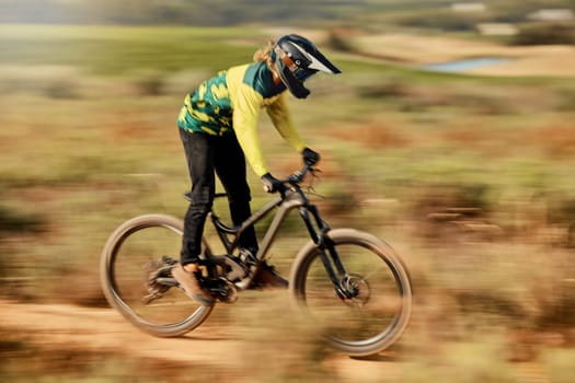 Speed, action and man on mountain bike for dirt racing sports, riding on nature trail. Sports, mountain biking and blur of athlete cycling fast on dirt road for fitness, adrenaline and adventure
