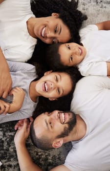 Above, family and portrait with children and parents on a floor, happy and relax while bonding in their home. Love, mother and kids with father on the ground for fun, laugh and playing in their house