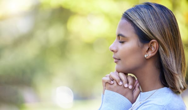 Prayer, peace and worship with woman in nature and mockup for God, spirituality and religion faith. Relax, calm and reflection with girl praying in park for health, wellness and meditation belief