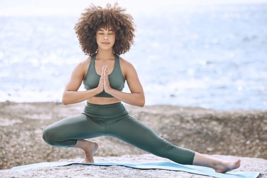 Beach, black woman and stretching legs for yoga balance, workout and exercise with focus. Calm fitness girl with afro in Los Angeles with mindfulness, body and wellness training at the ocean.