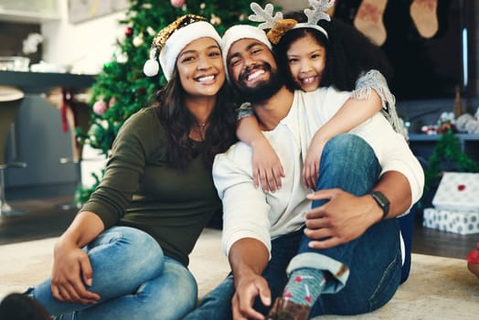 Portrait, Christmas and family celebration, happy or embrace together in living room. Xmas, love and mother with father, daughter and smile for holiday, hug or vacation for happiness, content or joy