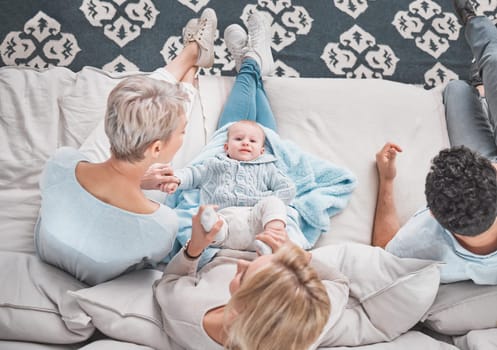 Bonding, above and baby with family on the sofa in the living room of their house with care. Love, happy and parents with grandmother and portrait of a child playing with affection on the couch