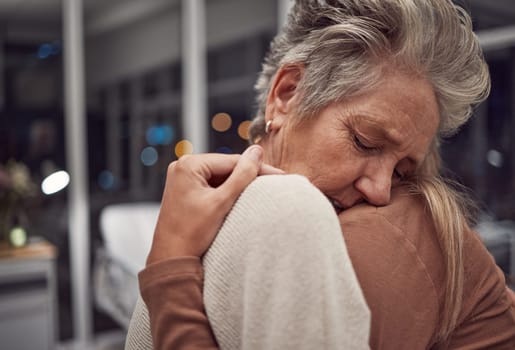 Hug, support and family at hospital to comfort after cancer diagnosis, disease or illness at night. Sad, depression and senior woman and girl hugging, embrace or cuddle for empathy, love and hope.