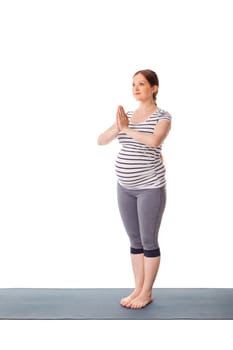 Pregnant woman doing yoga asana Tadasana Mountain pose