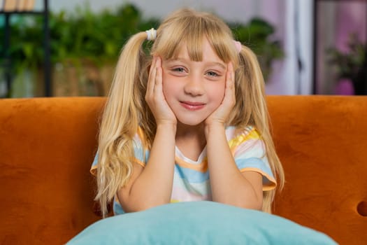 Portrait of happy smiling Caucasian preteen school girl child kid looking at camera, home play room